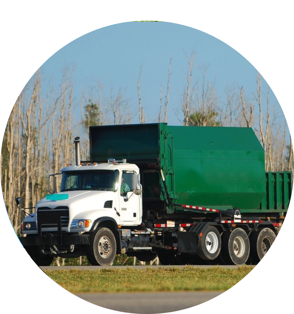 White garbage truck driving on road.