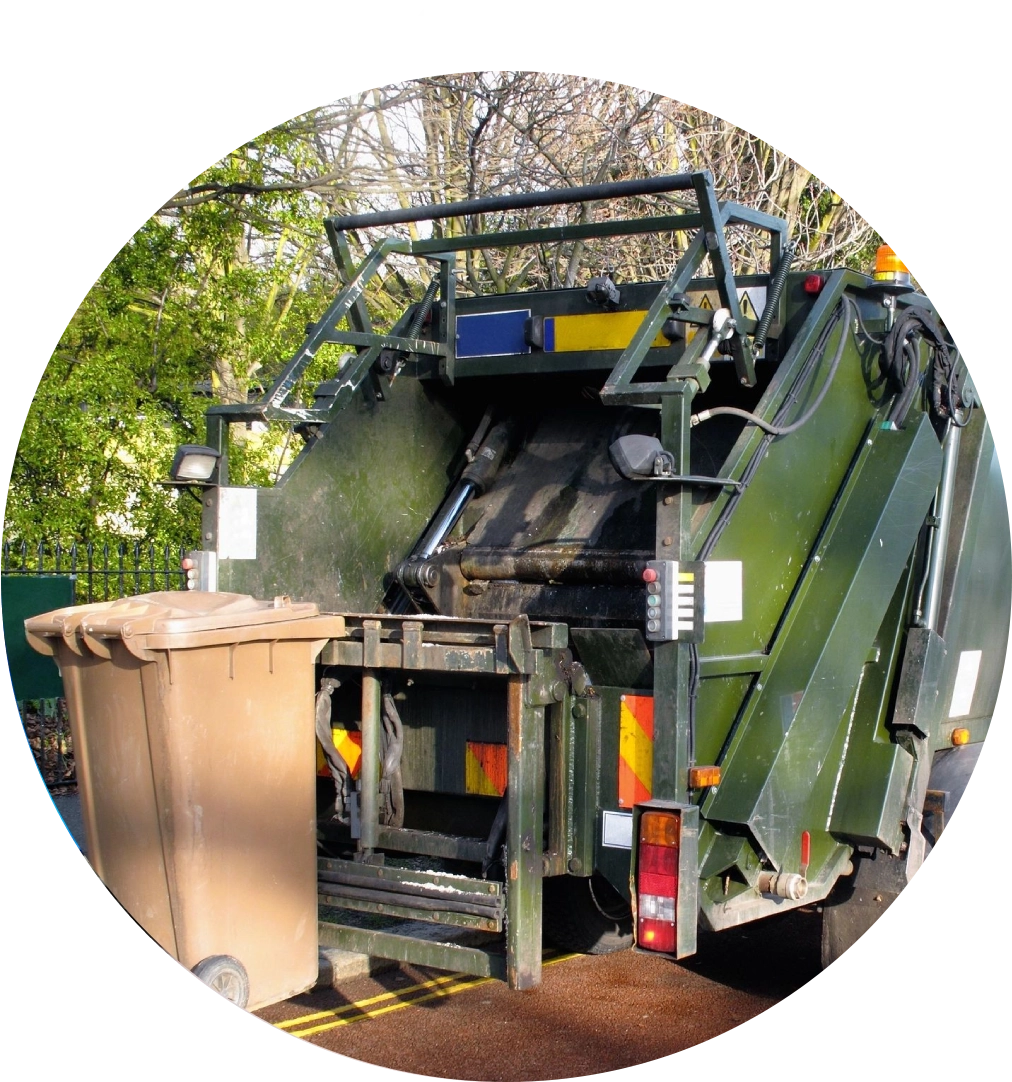 Green garbage truck with bins on the street.